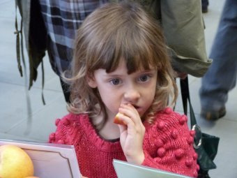 This little girl is trying an English Apple